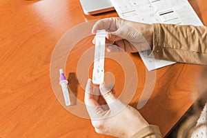 Hands of a woman holding an antigen test cassette for Covid19 self-test