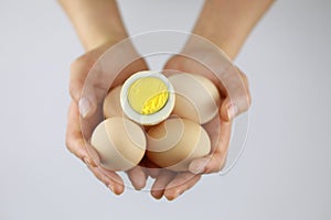 Hands of a woman holding fresh hen eggs