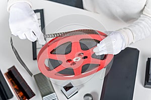 Hands woman holding red reel 16mm film