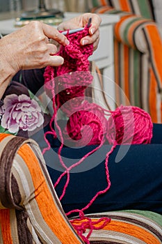 Hands of woman knitting a wool sweater