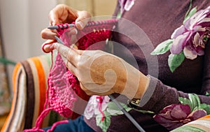 Hands of woman knitting a wool sweater