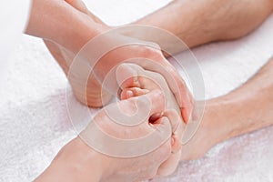 Hands of woman making foot massage