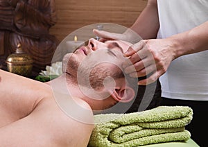 Hands of woman making massage to a man
