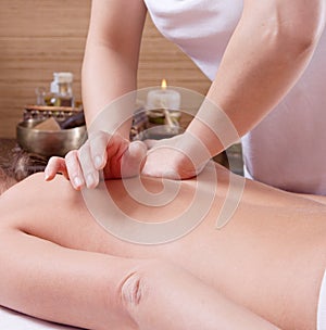 Hands of a woman making massage on a womans back