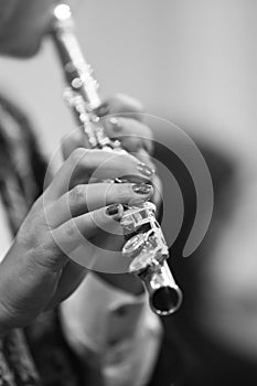 Hands of a woman playing the flute