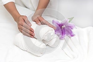 Hands of woman setting wellness decoration in spa salon backgrou