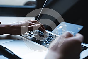 Hands of Woman shopping in Internet, making instant Payment Transaction at Computer, using Credit Card.