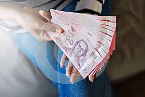 Hands woman show and counting Thai money