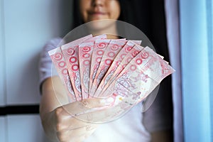 Hands woman show Thai money banknotes