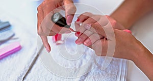 Hands on woman at spa, red nail polish with technician for beauty, luxury grooming and cosmetics. Professional manicure