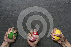 Hands of a woman squeezing a stress balls