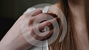 Hands of woman undressing white bra