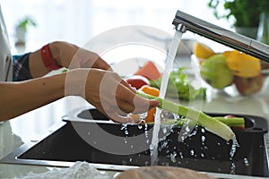 Hands woman washing vegetables. Preparation of fresh salad.