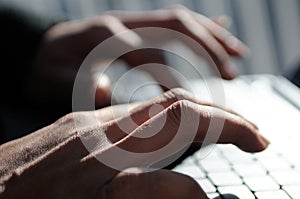 Hands of a woman writting with a laptop computer