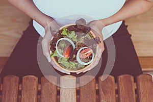 Hands woman holding healthy salad for breakfast in the morning,Clean eating and dieting