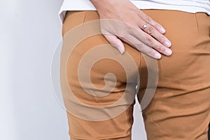 Hands woman holding her bottoms,Female need to pee,Urinary stain incontinence,Copy space for text on white background
