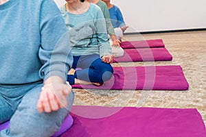 Hands of women in lotus position of yoga photo