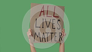 Hands of women raising up cardboard poster ALL LIVES MATTER. Stop Racism concept, No Racism. Rallies against racism and