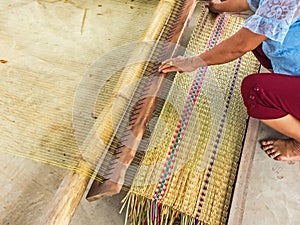 The hands of women woven mats traditional are products handmade in countryside of Thailand