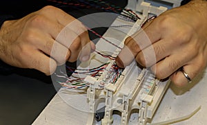 Hands at work in network cabling practice in an information technology classroom