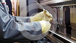 Hands of worker at automate machine on Industrial factory,