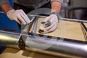 Hands of worker priming metal.