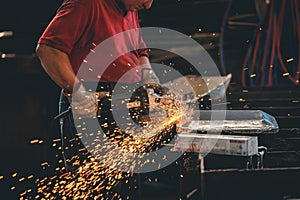 Hands of workers grinding steel in the metal industry