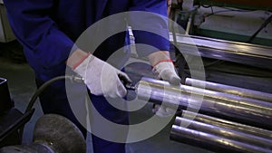 Hands working on the background of stainless steel pipes in factory.