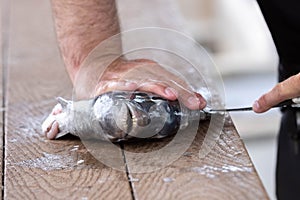 Hands Working Cleaning A Fish With Knife