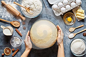 Hands working with dough preparation recipe bread, pizza or pie making ingridients, food flat lay