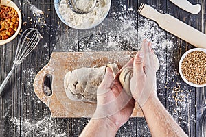 Hands working with dough preparation recipe bread, pizza or pie making ingridients, food flat lay on kitchen table background