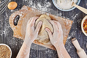 Hands working with dough preparation recipe bread, pizza or pie making ingridients, food flat lay on kitchen table background