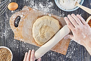 Hands working with dough preparation recipe bread, pizza or pie making ingridients, food flat lay on kitchen table background