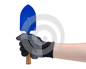 Hands in working gloves holding gardening tool shovel