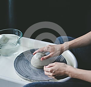 hands working on a potter& x27;s wheel