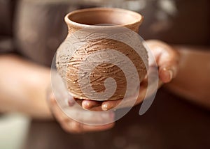 Hands working on pottery wheel