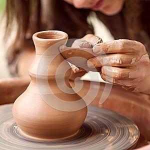 Hands working on pottery wheel