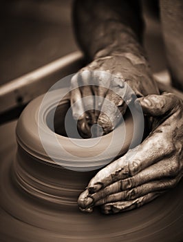 Hands working on pottery wheel