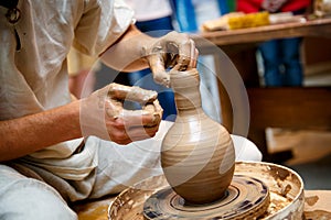 Hands working on pottery wheel