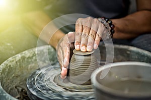 Hands working on pottery wheel