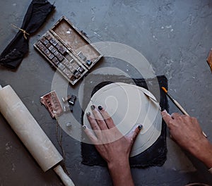 Hands working on pottery wheel , retro style toned