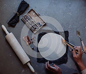 Hands working on pottery wheel , retro style toned