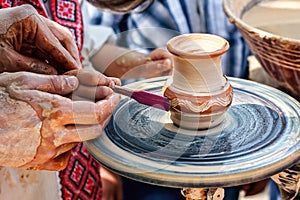 Hands working on pottery wheel. Sculptor, Potter. Human Hands creating a new ceramic pot.