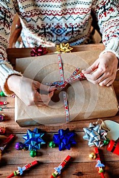 Hands wrapping Christmas gifts
