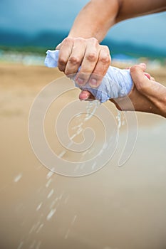 Hands wring out a wet cloth photo