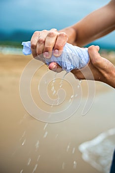 Hands wring out a wet cloth photo