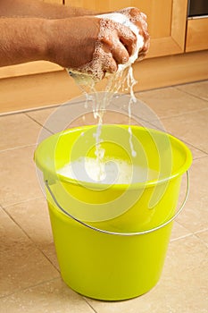 Hands wringing the water