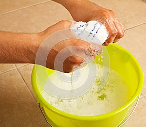 Hands wringing the water