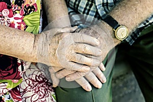 Hands with wrinkles of elderly couple, holding hands of seniors together close-up, concept of relationships, marriage