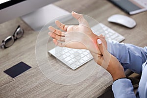 Hands, wrist pain and injury at desk in office with red glow, overlay and massage with burnout. Person, arthritis or